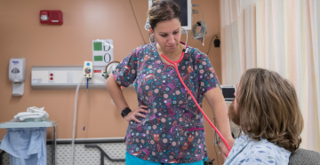 Nurse helping student