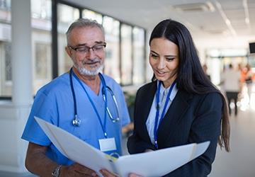 Doctor and administrator looking at patient chart