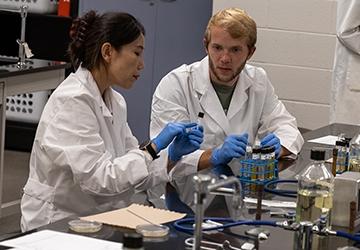 Students working together in lab with equipment