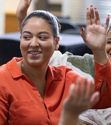 Center of Excellence student raising hand