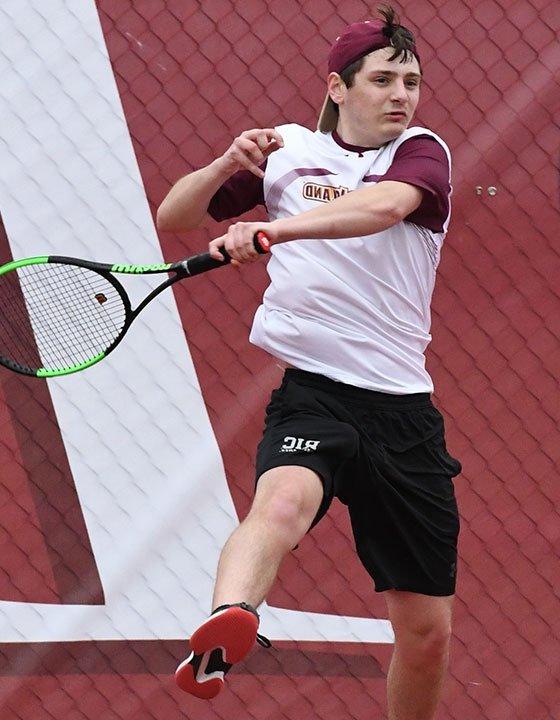 RIC student Eli Gouin playing tennis